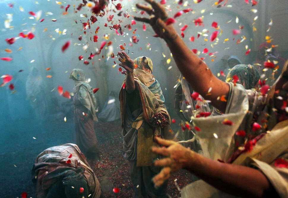 Indian Hindu widows throw flowers as part of Holi celebrations organized by the NGO Sulabh at the Meera Sahbhagini Ashram in Vrindavan. The widows, many of whom at times have lived desperate lives in the streets of the temple town, celebrated the festival for the first time at the century old ashram.