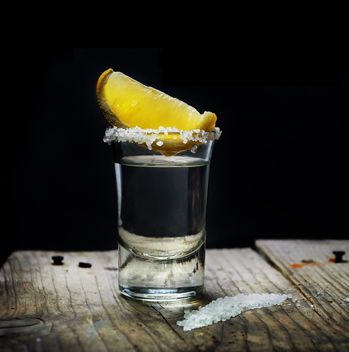 Tequila shot with lemon slice and salt