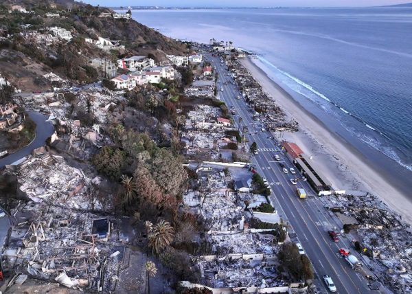 An aerial view shows the extent of the Palisades Fire on homes along the beach on Jan. 15 in Malibu.