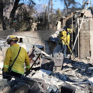 Firefighters search through the rubble of an Altadena property destroyed in the Eaton Fire.