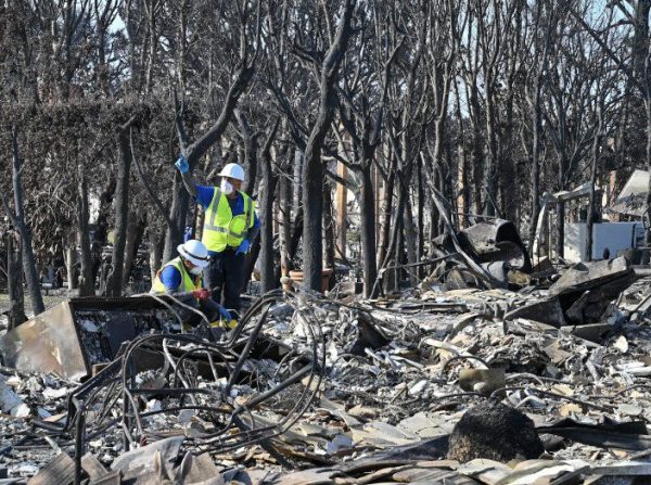 EPA workers search for hazardous materials to remove from a property destroyed during the January firestorm.