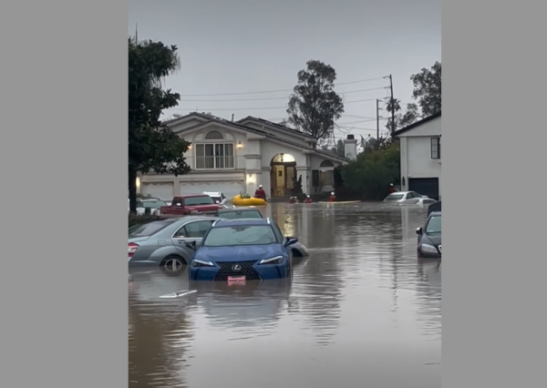 Cars sit in high water Friday in a Long Beach neighborhood after a water main broke.