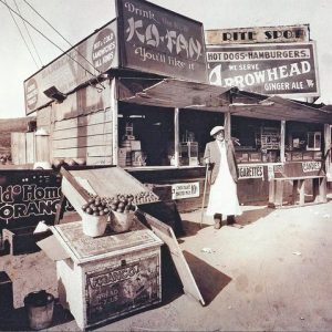 Lionel Sternberger is said to have invented the cheeseburger in the mid-1920s at this roadside snack stand on Colorado Boulevard in Pasadena. Pictured is Lionel's father, Herman Sternberger. The stand was later rebuilt as a restaurant named the Rite Spot. The photograph was displayed in at least one restaurant later operated by the family and appears to have been labeled to reflect the franchise name.