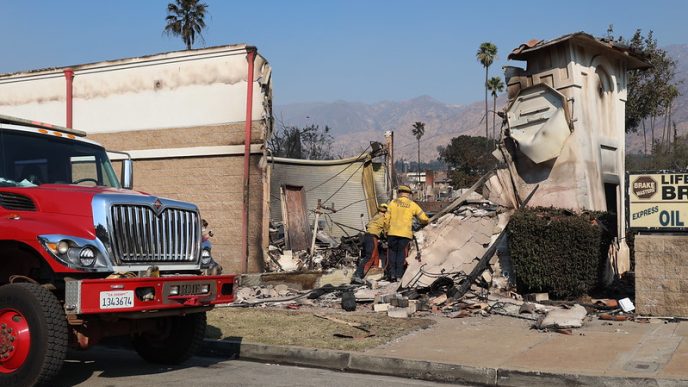 Firefighters enter a business destroyed in the Eaton Fire.