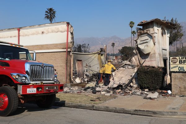 Firefighters enter a business destroyed in the Eaton Fire.