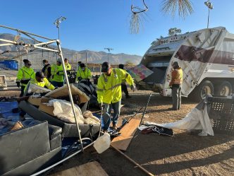 A crew of workers clears an encampment in December at Wildwood Park in San Bernardino.