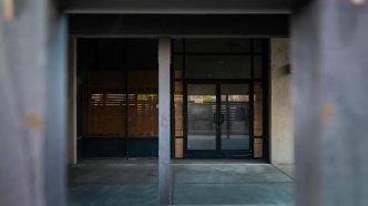 A shuttered door remains at a homeless shelter in Anaheim that is permanently shut down and partially boarded up.