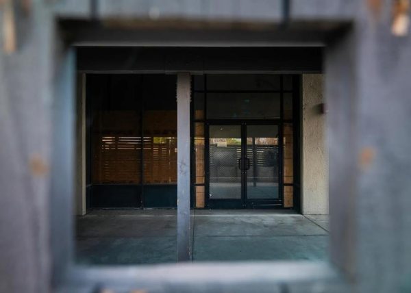 A shuttered door remains at a homeless shelter in Anaheim that is permanently shut down and partially boarded up.