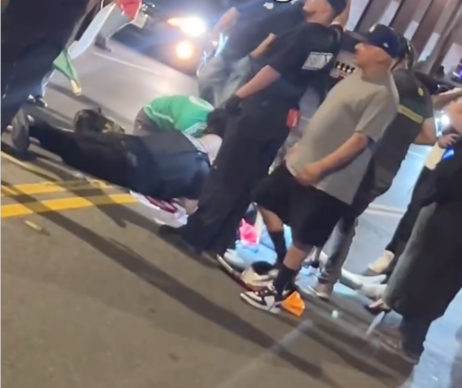 People surround a woman who had just been run over during a protest in Riverside June 14, 2025.