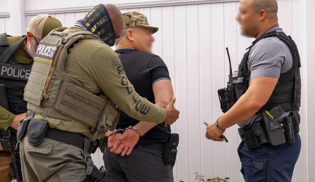Federal agents detain a man in May 2025 for allegedly violating immigration law.