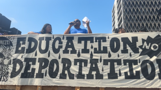 Activists decry immigration raids in the Los Angeles area during a "community stoppage" event.
