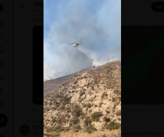 A helicopter drops water on the Canyon Fire near the Ventura and Los Angeles county line.
