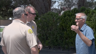 Kevin Bourke speaks with San Bernardino County sheriff's deputies.