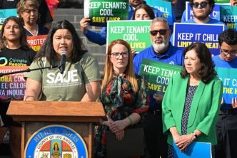 Fair housing advocate Jannet Torres, at podium, joins LA County Supervisors Lindsey Horvath, second from right, and Hilda Solis to announce the board's approval of a law requiring a maximum temperature of 82 degrees in rental units.