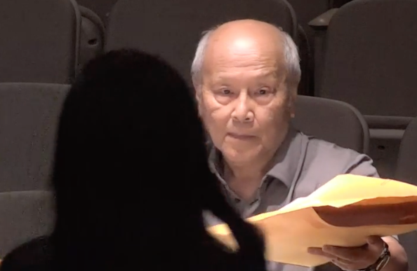 Arcadia resident Benny Yee hands documents to City Clerk Linda Rodriguez as he serves the city with a lawsuit over the council's censure of Mayor Sharon Kwan.