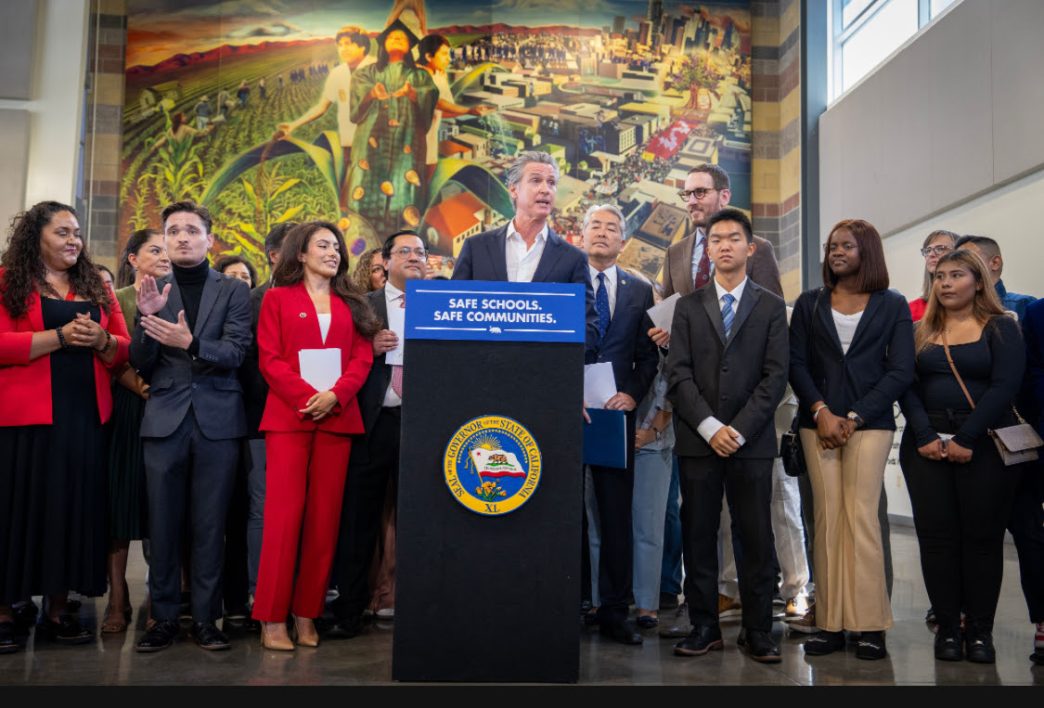 Gov. Gavin Newsom gathers with local and state officials in LA to sign bills that aim to restrict immigration raids.