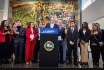 Gov. Gavin Newsom gathers with local and state officials in LA to sign bills that aim to restrict immigration raids.