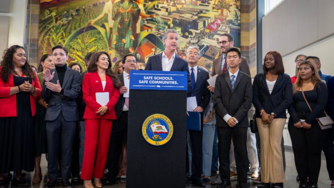 Gov. Gavin Newsom gathers with local and state officials in LA to sign bills that aim to restrict immigration raids.