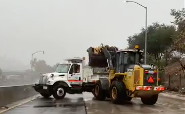 Caltrans vehicles clear mud from the 110 Freeway near Avenue 43 in Montecito Heights.