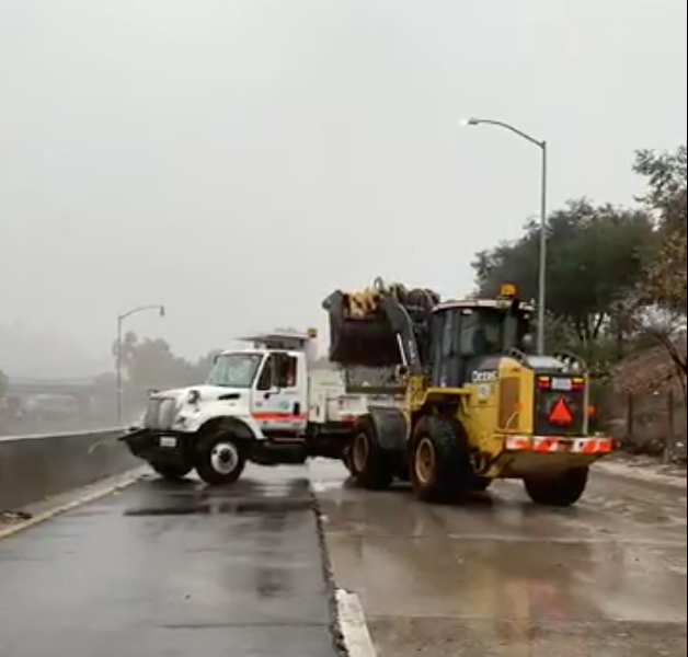 Caltrans vehicles clear mud from the 110 Freeway near Avenue 43 in Montecito Heights.