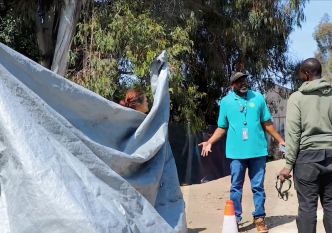 Participants in the 2025 count speak with a man experiencing homelessness.