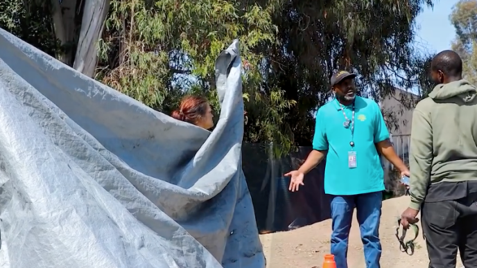 Participants in the 2025 count speak with a man experiencing homelessness.