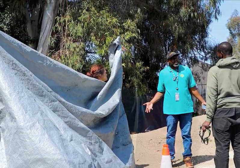 Participants in the 2025 count speak with a man experiencing homelessness.