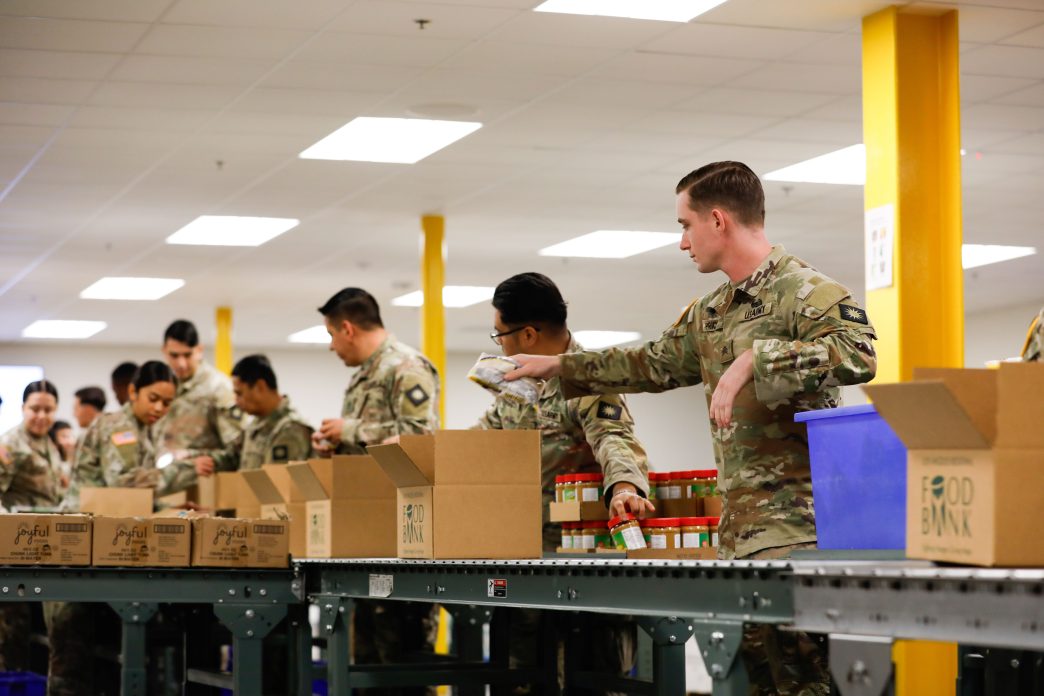 California National Guard troops prepare meals for distribution at a food bank in the City of Industry.