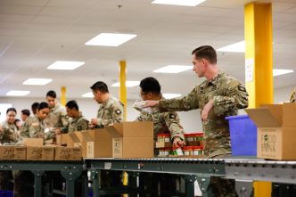 California National Guard troops prepare meals for distribution at a food bank in the City of Industry.