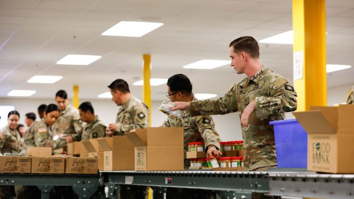 California National Guard troops prepare meals for distribution at a food bank in the City of Industry.