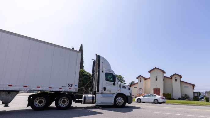 A semitruck leaves a warehouse across the street from St. Mark’s Missionary Baptist Church on June 8 in San Bernardino.
