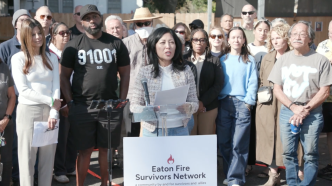 Eaton Fire Survivors Network Executive Director Joy Chen, at podium, network members and Palisades Fire survivors call on state Insurance Commissioner Ricardo Lara to resign.