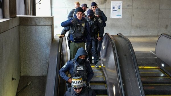 Federal and local law enforcement teams patrol the Farragut West Metro station Nov. 27 in Washington, D.C.