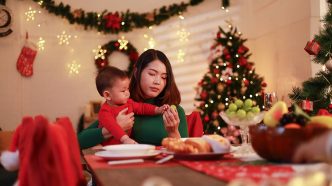 A woman and a baby at a holiday table.