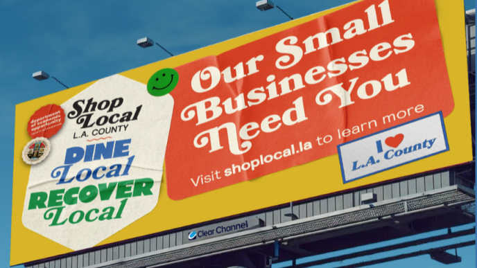 A billboard advertises the county's Shop Local. Dine Local. Recover Local. Campaign.