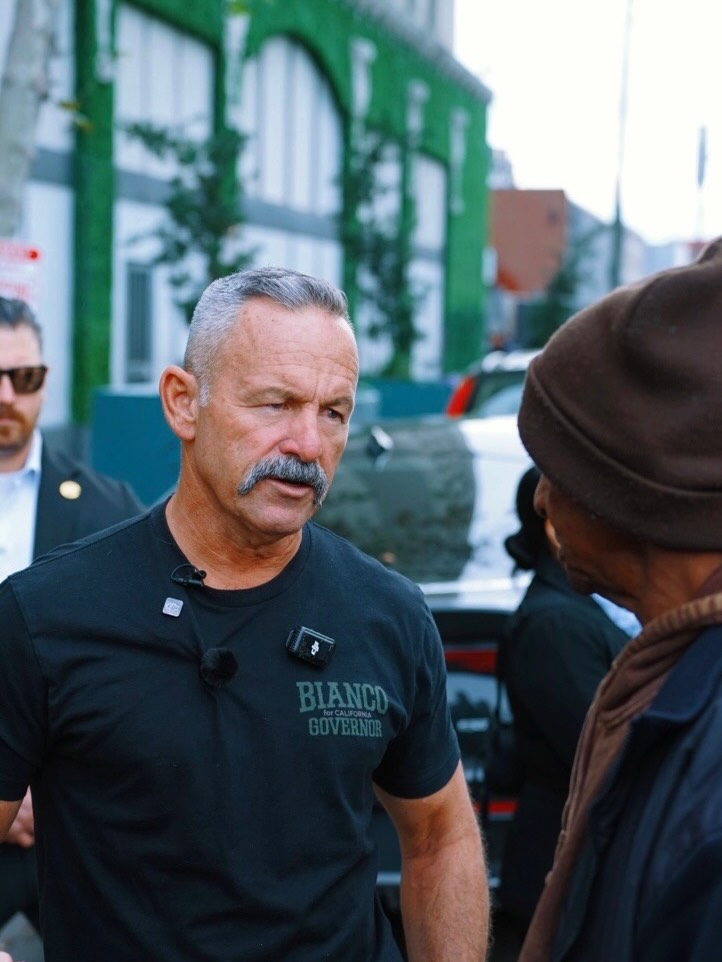 Riverside County Sheriff Chad Bianco speaks with an unidentified Angeleno during his tour through homeless encampments on Skid Row in downtown Los Angeles.