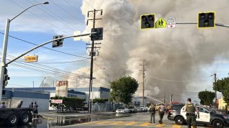 Columns of smoke fill the air above a blaze at a recycling facility in El Monte.