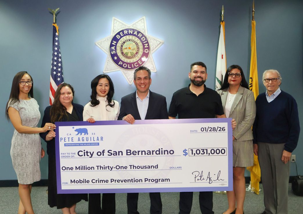 Rep. Pete Aguilar, D-San Bernardino, fourth from left, presents city officials with a ceremonial check for more police surveillance equipment.