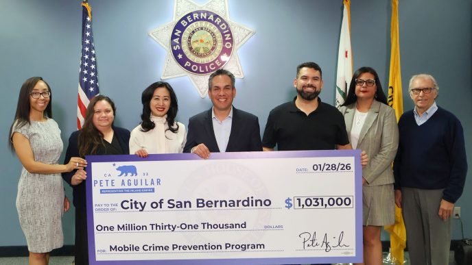 Rep. Pete Aguilar, D-San Bernardino, fourth from left, presents city officials with a ceremonial check for more police surveillance equipment.