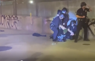 LAPD officers arrest a man during an anti-ICE protest in downtown LA late Saturday, Jan. 31, 2026.