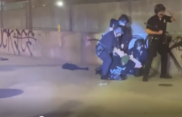 LAPD officers arrest a man during an anti-ICE protest in downtown LA late Saturday, Jan. 31, 2026.