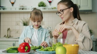 A woman and young girl prepare lunch.