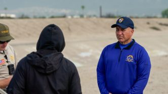 District 5 county Supervisor Joe Baca Jr. and a member of the Sheriff's Department speak with a person experiencing homelessness during the 2026 point-in-time-count in January.