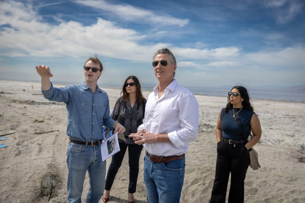 Gov. Gavin Newsom, third from left, and officials survey the dried areas of the Salton Sea ahead of a newly formed local conservancy.