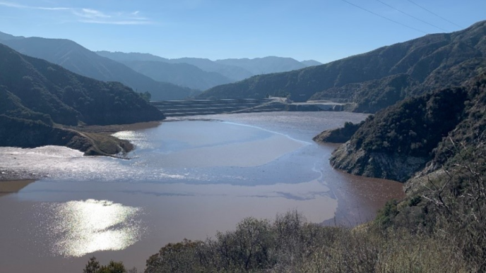 Strong storms brought tons of sediment and debris into the San Gabriel Reservoir during the winter after the 2024 Bridge Fire.