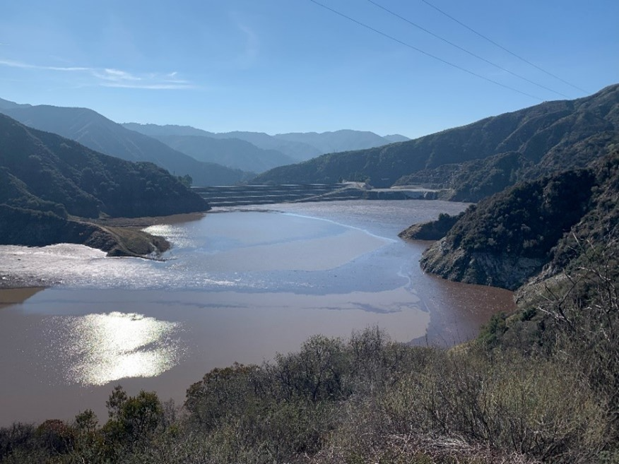 Strong storms brought tons of sediment and debris into the San Gabriel Reservoir during the winter after the 2024 Bridge Fire.