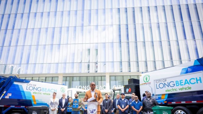 Mayor Rex Richardson joins other Long Beach officials and community members to unveil the city's first electric garbage collection trucks.