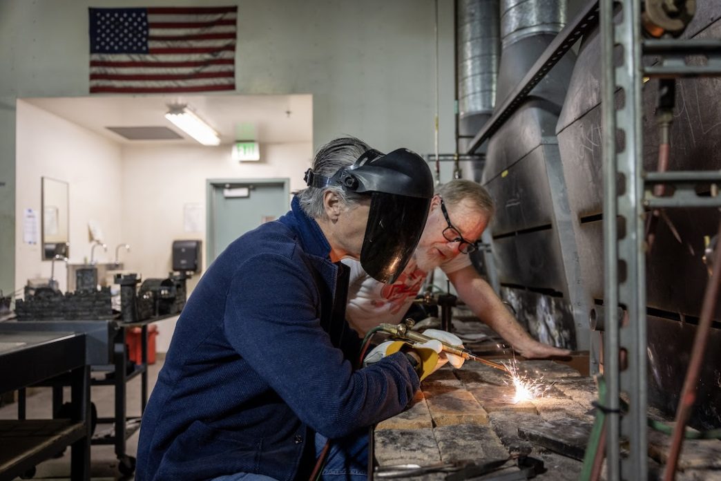 Gov. Gavin Newsom, at right, welds during his visit Friday, May 1 to Pasadena City College.