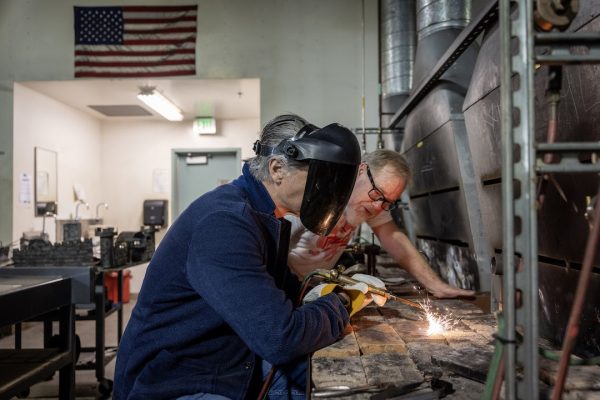 Gov. Gavin Newsom, at right, welds during his visit Friday, May 1 to Pasadena City College.