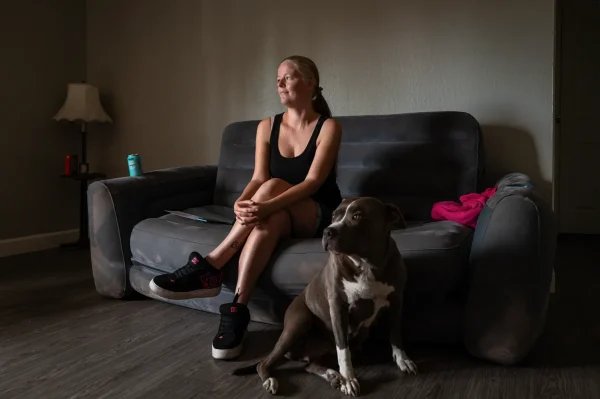 Jessica Scott, 35, and her pitbull Baby Girl inside their new apartment in Sacramento on July 1, 2026.